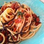 spaghetti con alghe arame pomodori secchi pinoli e rucola